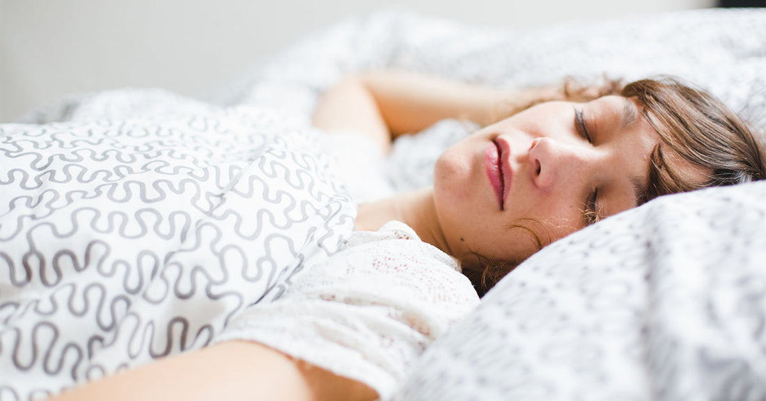 Woman sleeping in a cozy bed
